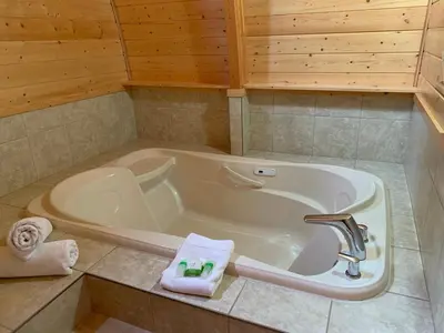 a bathroom with a tub and a sink at Oyster Bay Resort in Oyster Bay
