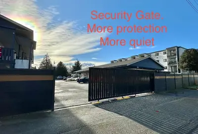 a parking lot with asecurity gate more protection more quiet at Duncan Motel in Duncan