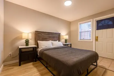 a bedroom with a bed with two night stands and two lamps at Riverside Condos by Fernie Central Reservations in Fernie