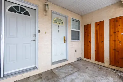 a garage with two white doors on a wall at Riverside Condos by Fernie Central Reservations in Fernie