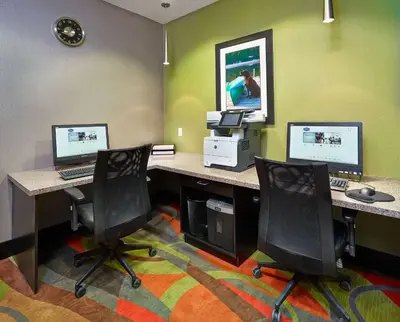 an office with two desks with two computers and two chairs at Hampton Inn by Hilton Calgary Airport North in Calgary