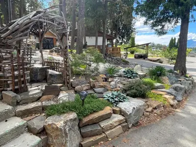 a garden with rocks and plants in a yard at The Valley View Cabins and Event Center in Creston