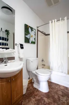 a bathroom with a white toilet and a sink at The Valley View Cabins and Event Center in Creston