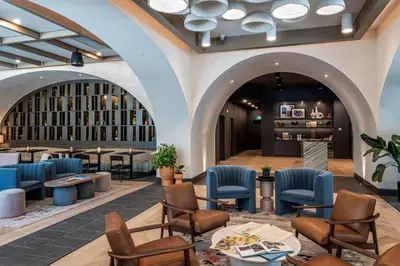 a lobby of a hotel with chairs and tables at The Westley Calgary Downtown, Tapestry Collection By Hilton in Calgary