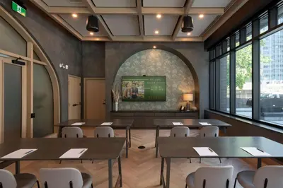 a dining room with tables and chairs and a tv at The Westley Calgary Downtown, Tapestry Collection By Hilton in Calgary