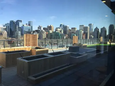 a rooftop garden with a view of a city at Kensington Suite 2bed & 1bath in Calgary