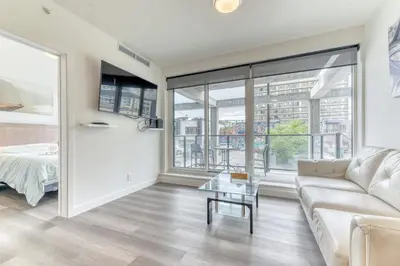 a living room with a couch and a table at Kensington Suite 2bed & 1bath in Calgary