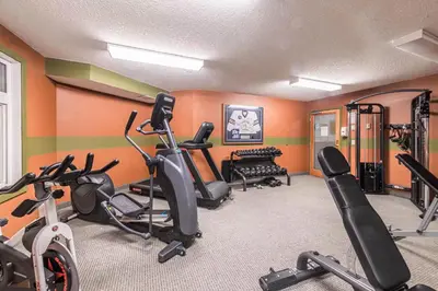 a gym with several exercise bikes in a room at Windtower Lodge Queen Bed Suite-UGParking&Walking2DT in Canmore
