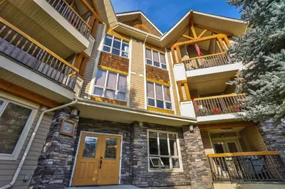 an apartment building with a porch and balcony at Sable Ridge Condos by StayIn in Radium Hot Springs