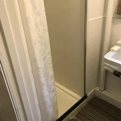 a shower curtain in a bathroom with a sink at Holiday Lodge Cabins in Banff
