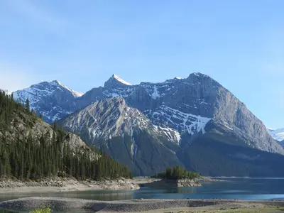 a mountain range with a lake in the foreground at Apartment 406, Indigenous Artefacts in Canmore