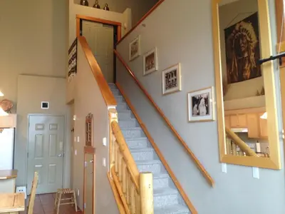 a stairway in a home with a stair case at Apartment 406, Indigenous Artefacts in Canmore