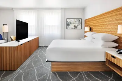 a bedroom with a large white bed and a television at Delta Hotels by Marriott Grande Prairie Airport in Grande Prairie