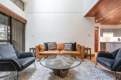 a living room with a couch and two chairs and a table at Snowberry by Outpost Whistler in Whistler