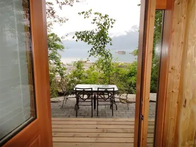 a view of a patio with a table and chairs at Porteau Cove Olympic Legacy Cabins in Furry Creek
