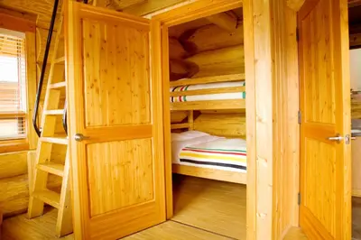 a wooden cabin with two bunk beds in it at Porteau Cove Olympic Legacy Cabins in Furry Creek