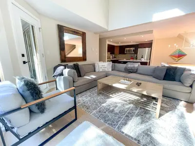a living room with a couch and a table at 3BR in Gleneagle, Ski Storage, Wood Burning Fireplace, Free Shuttle in Whistler