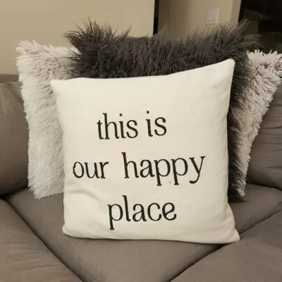 a pillow that says this is our happy place at 3BR in Gleneagle, Ski Storage, Wood Burning Fireplace, Free Shuttle in Whistler