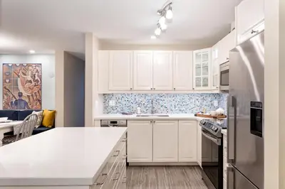 a kitchen with white cabinets and a white counter top at Renovated & Spacious 1bed/2bath Whistler Village in Whistler