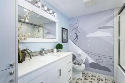 a bathroom with a sink and a toilet and a mirror at Renovated & Spacious 1bed/2bath Whistler Village in Whistler