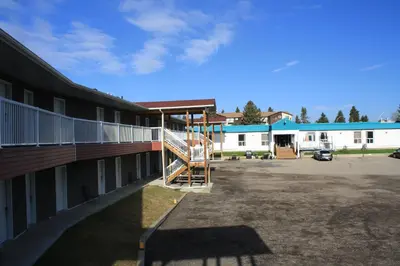 a building with a staircase in a parking lot at CHINOOK INN in Rocky Mountain House
