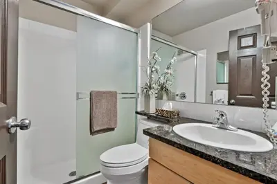 a bathroom with a sink and a toilet and a mirror at Mystic Getaway in Canmore