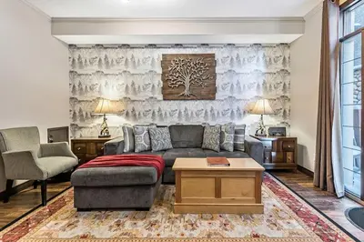 a living room with a couch and a table at Mystic Getaway in Canmore
