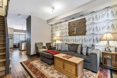 a living room with a couch and a table at Mystic Getaway in Canmore