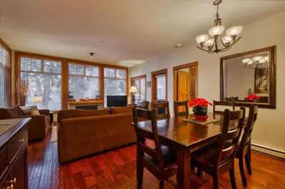 a living room with a table and a couch at Settlers Crossing #08 by Bear Country in Sun Peaks