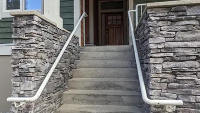 a set of stone stairs leading to a house at Settlers Crossing #08 by Bear Country in Sun Peaks