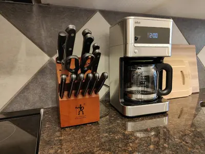 a counter with a coffee maker and a block of knives at The Lambeth by Samsara Resort Private Entry Panorama Top View 2BR and 2BTH in Canmore