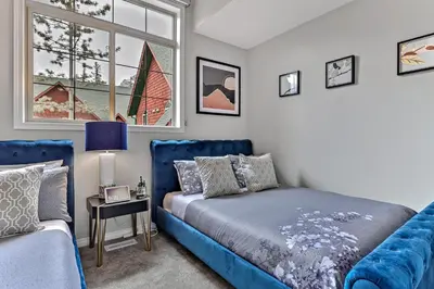 a bedroom with a bed and a couch and a window at The Lambeth by Samsara Resort Private Entry Panorama Top View 2BR and 2BTH in Canmore
