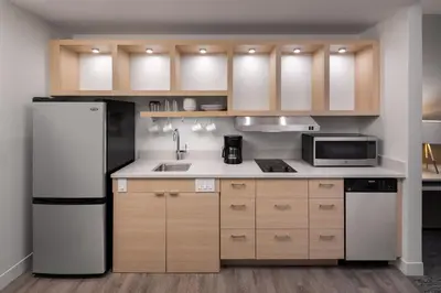 a kitchen with a refrigerator and a microwave at TownePlace Suites by Marriott West Kelowna in West Kelowna