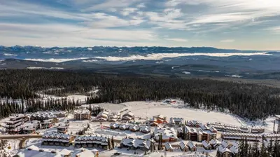 an aerial view of a ski resort in the snow at Forest Lane Hideaway - Luxurious Family Friendly Home w Private Hot Tub in Big White