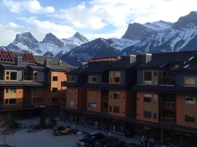 a group of buildings with mountains in the background at Apartment 411, Antique Heritage in Canmore