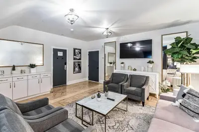 a living room with two couches and a table at The Inn on Officers' Garden in Calgary
