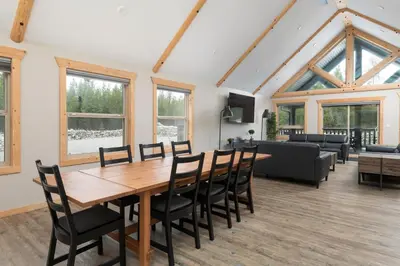 a living room with a wooden table and chairs at Lazy Moose in Valemount
