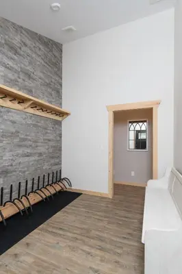 a room with a white couch and a brick wall at Lazy Moose in Valemount