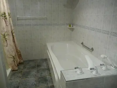 a white bath tub in a bathroom with a shower at Sonora Desert Inn in Osoyoos