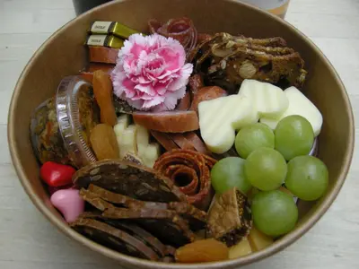 a bowl filled with different types of vegetables and grapes at Sonora Desert Inn in Osoyoos