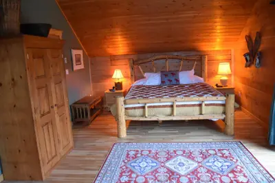 a bedroom with a bed and two lamps in a room at Seven Sisters Mountains House in Kitwanga