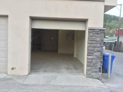 a garage with a door open in a building at Lily glacier suite at silver bear condos in Revelstoke