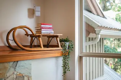 a pile of books on a table next to a window at 2BR in Symphony, Dog Friendly, Hot Tub, Private Balconies, Village Location, Parking in Whistler