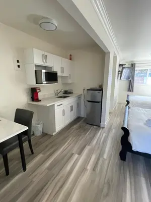 a room with a kitchen and a bed and a table at Destination INN in Radium Hot Springs