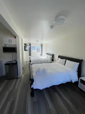 a large bedroom with two beds and a television at Destination INN in Radium Hot Springs