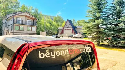 a red bus is parked in front of a house at Silver Birch by StayIn in Kimberley