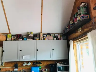 a kitchen with white cabinets and a bunch of canned food at Jade Fever Cabina in Jade City