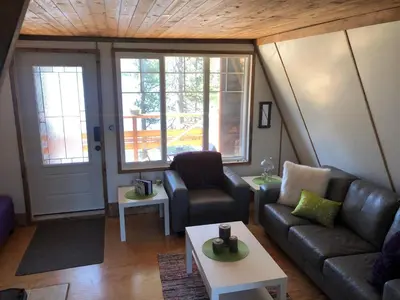 a living room with a couch and a table at Cooks and Puppies Hideaway in Jade City