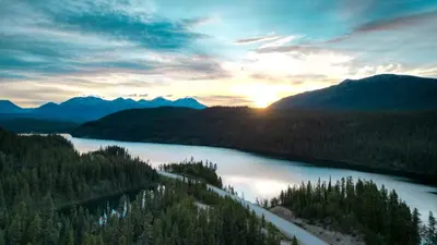 a view of a river with trees and mountains at Cooks and Puppies Hideaway in Jade City