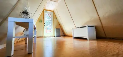 a room with a wooden floor and a white cabinet at Cooks and Puppies Hideaway in Jade City